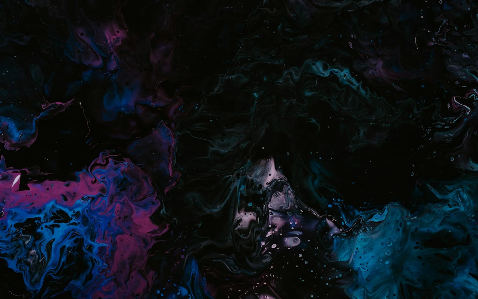 Marbled paint in magenta, blue and teal drifting across a black field.