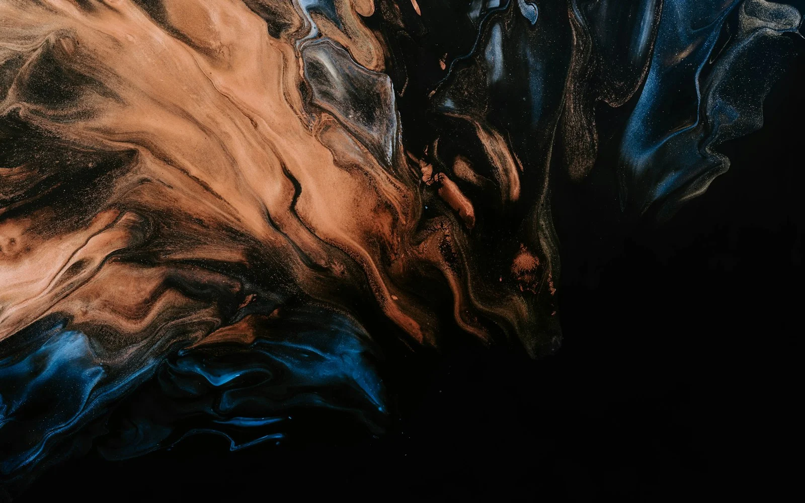 Marbled paint, copper and deep blue swirling together against black.